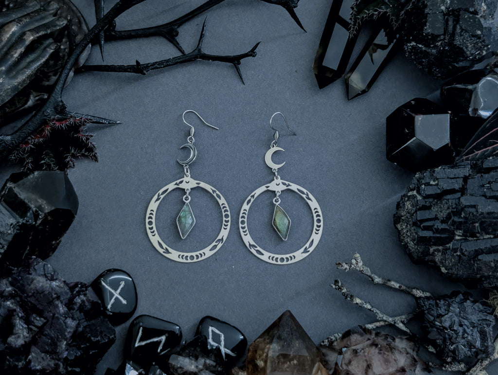 Handcrafted stainless steel snake earrings, featuring labradorite, created by Hexian in Australia.