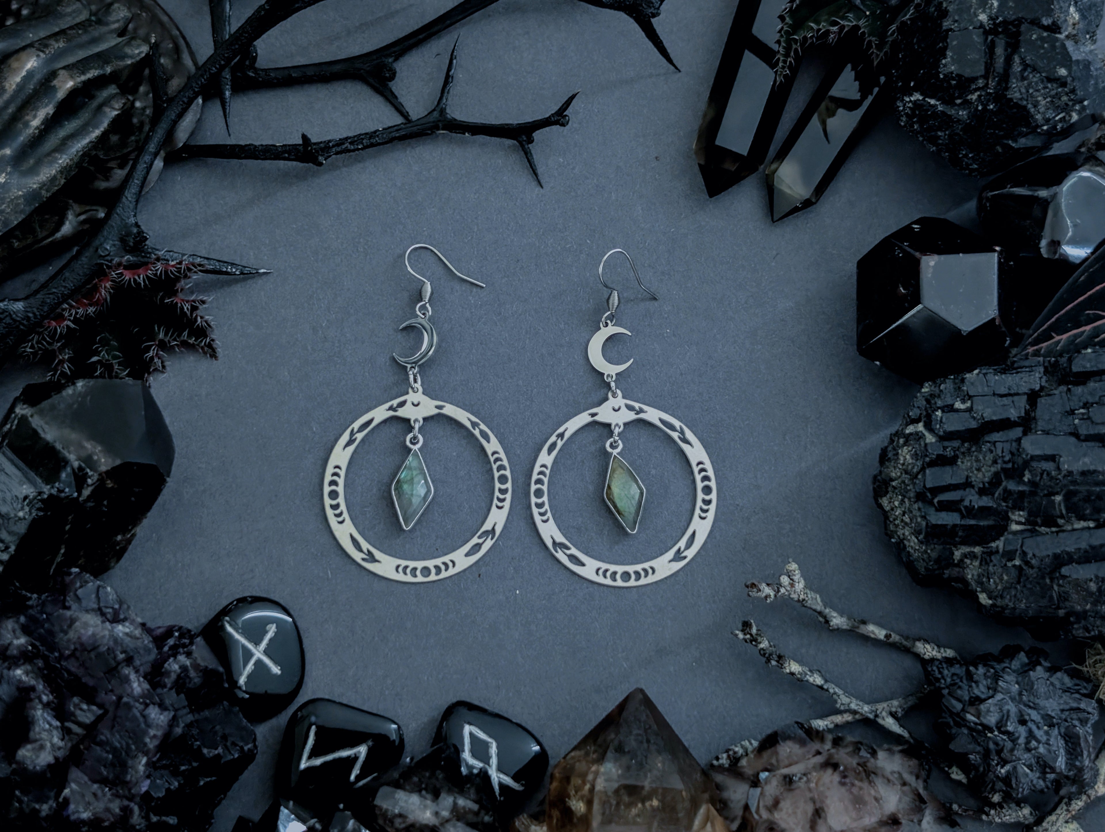 Handcrafted stainless steel snake earrings, featuring labradorite, created by Hexian in Australia.